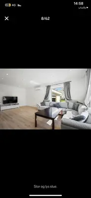 a living room with a couch and a table at et fint og stort enebolig sentralt i voss! in Vossevangen