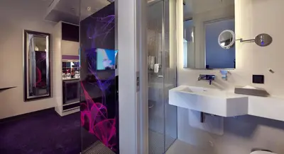 a bathroom with a sink and a mirror at Hotel Oleana in Bergen