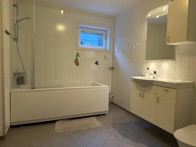 a white bathroom with a tub and a sink at World championship, VM på ski Granåsen 2025 in Trondheim