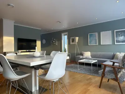 a living room with a couch and a table and chairs at World championship, VM på ski Granåsen 2025 in Trondheim