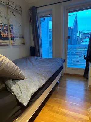 a bedroom with a bed and a large window at World championship, VM på ski Granåsen 2025 in Trondheim