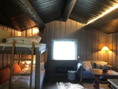 a bedroom with two bunk beds and a window at Cozy cabin 1,5 hours from Oslo in Hamar