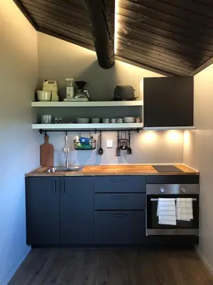 a kitchen with blue cabinets and a sink at Cozy cabin 1,5 hours from Oslo in Hamar