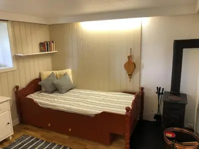 a bedroom with a bed in a room at Cabin with large outdoor area in Hamar