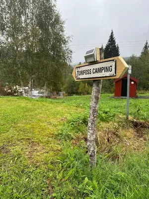a sign for homeless camping in a field at Turifoss Camping Cabin 2 in Svedjan