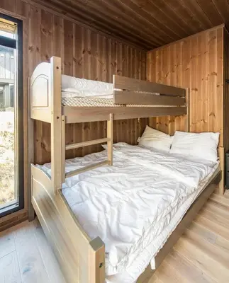 a bedroom with two bunk beds in a cabin at Modern cabin Hafjell high standard ski-in out in Hafjell