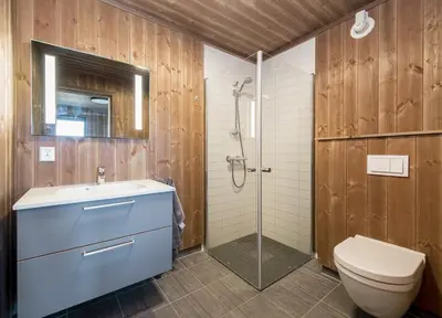 a bathroom with a toilet and a sink and a shower at Modern cabin Hafjell high standard ski-in out in Hafjell