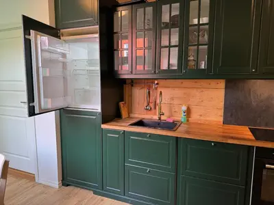 a kitchen with green cabinets and a sink at Lake view apartment in center of Bergen - 3 bedrooms in Bergen