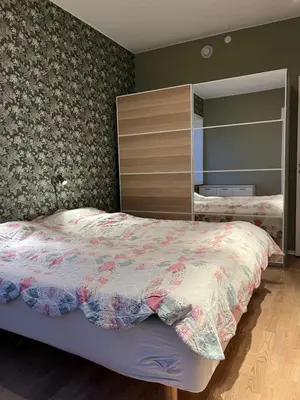 a bedroom with a bed and a large mirror at Attraktiv utsiktsleilighet in Ranheim