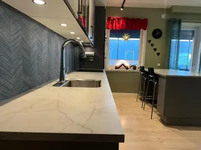 a kitchen with a sink and a counter top at Attraktiv utsiktsleilighet in Ranheim