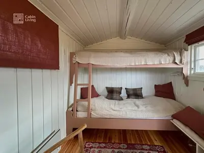 a bedroom with a bunk bed in a house at Cozy cabin near Geilo & Dagali terrace, grill, fireplace, view & WiFi in Hol
