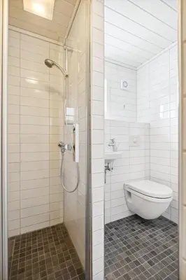 a bathroom with a shower and a toilet in it at Idyllisk perle ved sjøen! in Frøya