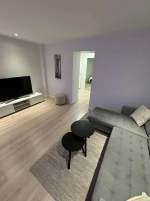 a living room with a couch and a table at Mint Apartment in Ålesund