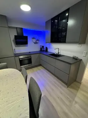 a kitchen with a table and chairs in a room at Mint Apartment in Ålesund