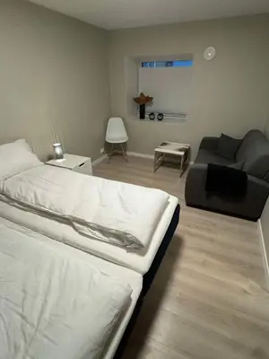 a living room with a bed and a couch at Mint Apartment in Ålesund