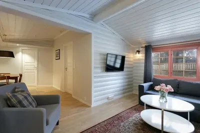 a living room with a couch and a table at Cozy apartment with pool in Bjorli