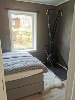 a bedroom with a bed and a window and a vacuum at Lovely apartment with stunning views in Torset