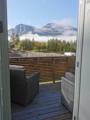 a balcony with two chairs and a view of a mountain at Lovely apartment with stunning views in Torset