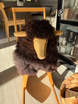 a stuffed animal sitting on top of a wooden chair at Modern & cozy house in Trondheim
