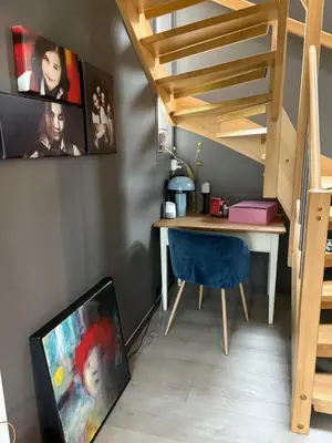a room with a desk and a staircase with a blue chair at Modern & cozy house in Trondheim