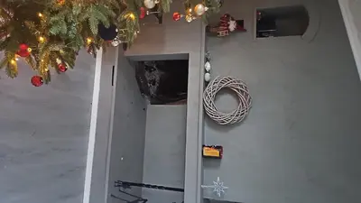 a door with a wreath on it with a christmas tree at Casa Knott 4 Bedroom in Ulstein