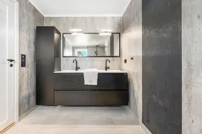 a bathroom with a sink and a mirror at Casa Knott 4 Bedroom in Ulstein