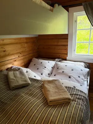 a bed with two pillows on it in a bedroom at Chalet Skogshorn in Markegardlian