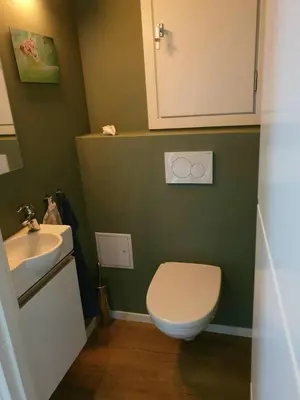a bathroom with a toilet and a sink at Spacious house close to Ski World Championship in Trondheim