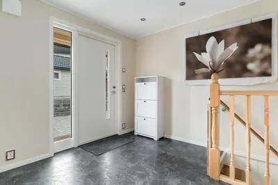 a room with a staircase and a painting on the wall at Spacious house close to Ski World Championship in Trondheim
