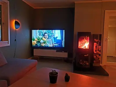 a living room with a television and a fireplace at Spacious house close to Ski World Championship in Trondheim