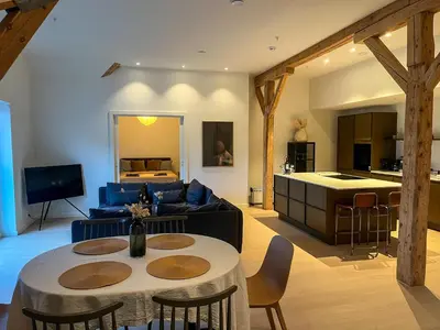 a living room with a couch and a table at MARINA LUXE - Two Bedrooms, High-End, Iconic Location & Private Parking in Ålesund