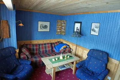 a living room with a couch and two chairs at Cozy cabin centrally located in Hovden in Hovden