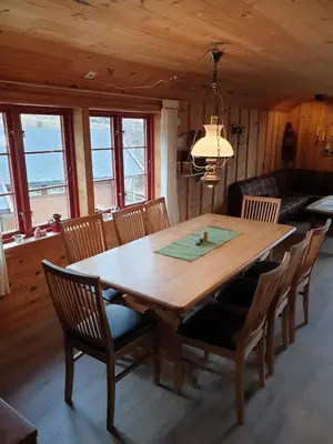 a dining room with a wooden table and chairs at Cozy cabin centrally located in Hovden in Hovden