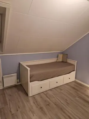 a bed in the corner of a room at Granåsen World Championship Stay Walk to Ski Arena in Trondheim