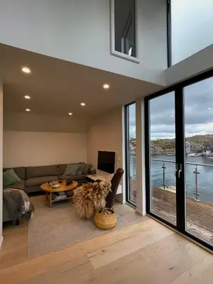 a living room with a couch and a table at Modern seaside holiday home in Bømlo