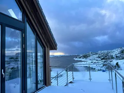 a house with a view of the water from a balcony at Modern seaside holiday home in Bømlo