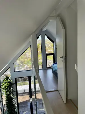a staircase in a house with glass doors at Modern seaside holiday home in Bømlo