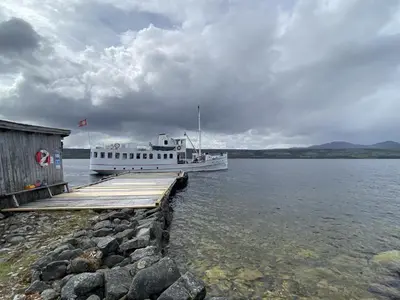 a boat is docked at a dock on the water at Family cabin by the lake at Haugen, Femundsmarka in Elga
