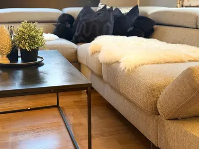 a living room with a couch and a table at Peace in the heart of nature in Trysil