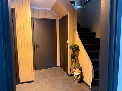 a cat is sitting in front of a door at Peace in the heart of nature in Trysil