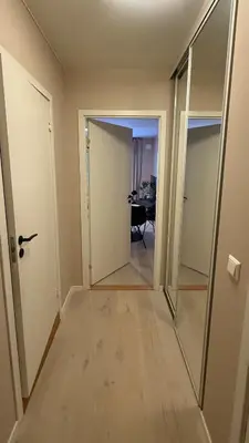 an empty hallway with a door and a dining room at Delicate Central Apartment Trondheim in Trondheim