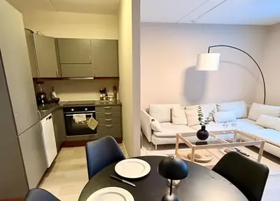 a living room with a table and a couch at Delicate Central Apartment Trondheim in Trondheim