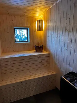 a sauna with a window and a bench in it at New modern cabin in Beitostølen in Beitostøl
