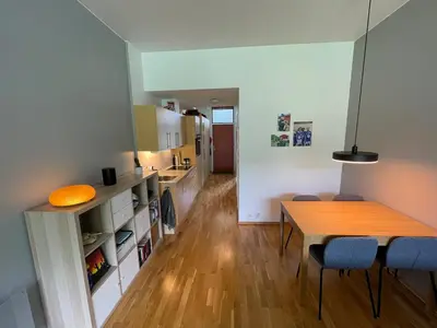 a kitchen and dining room with a table and chairs at Cozy 1-bedroom in quiet Ilsvika in Trondheim