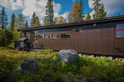 a wooden house with a train on the tracks at Trysilfjellet Sør 17 in Trysil