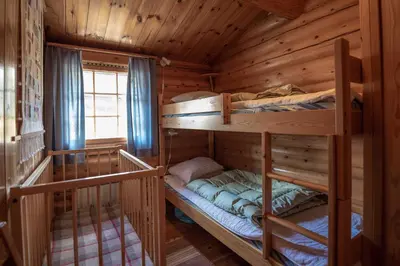 a bedroom with two bunk beds in a log cabin at Trysilfjellet Sør 204 in Trysil