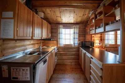 a kitchen with wooden cabinets and a sink at Trysilfjellet Sør 204 in Trysil
