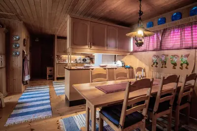 a kitchen with a table and chairs in a room at Trysilfjellet Nord 607 in Trysil
