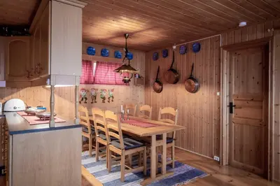 a kitchen with a wooden table and chairs at Trysilfjellet Nord 607 in Trysil