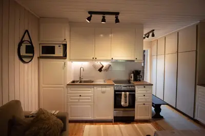 a kitchen with white cabinets and a stove top oven at Trysilfjellet Nord 1071B in Trysil